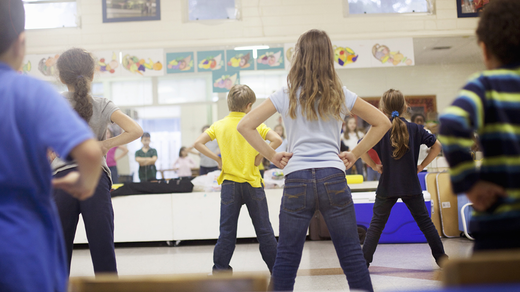 Kids doing exercises together in a classroom