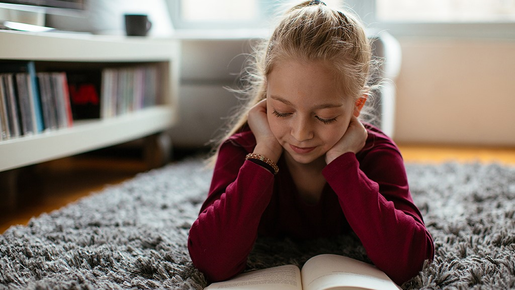 young girl reading a book- Sanford fit