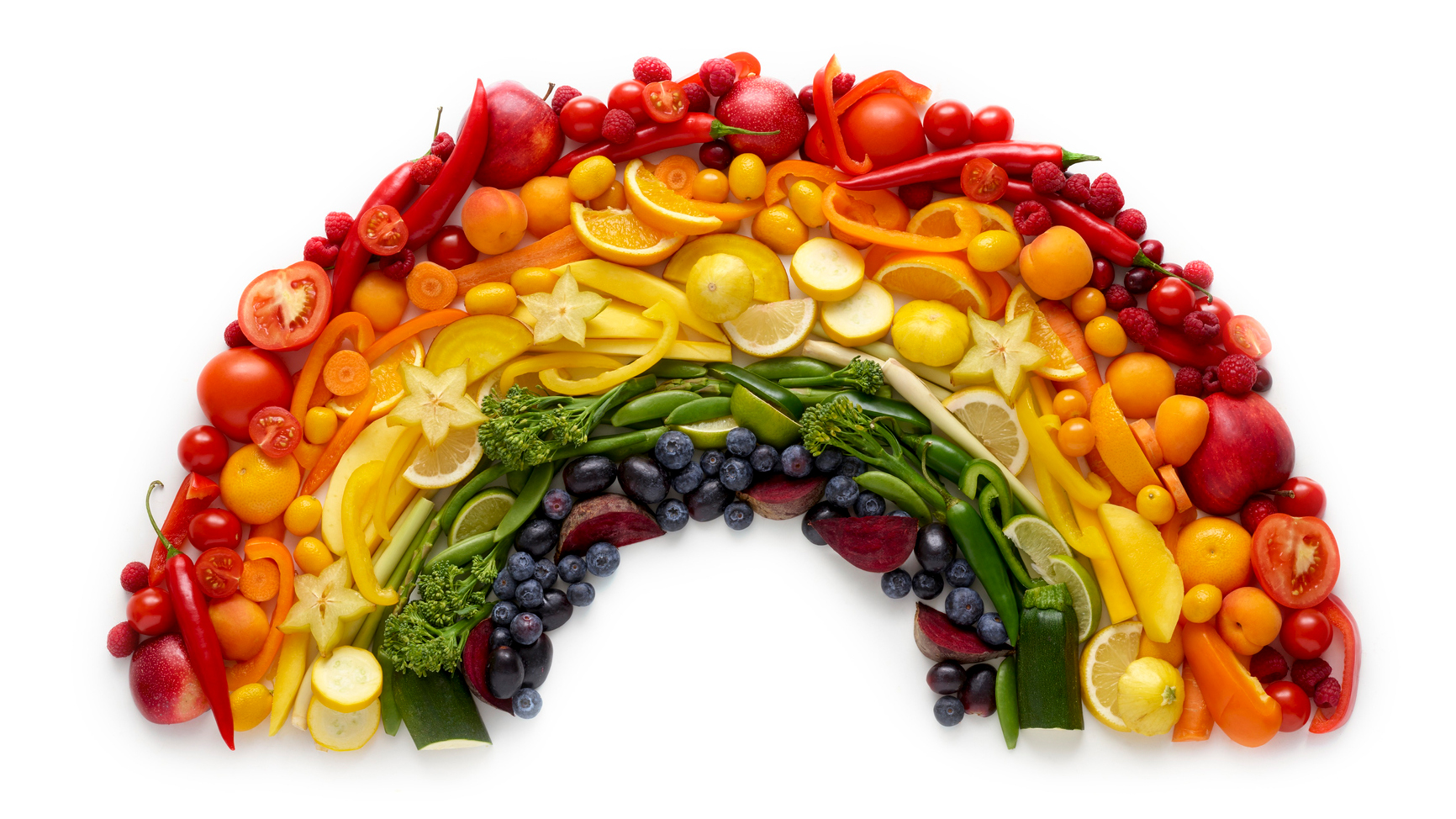 fresh fruits and veggies arranged into a rainbow made of food