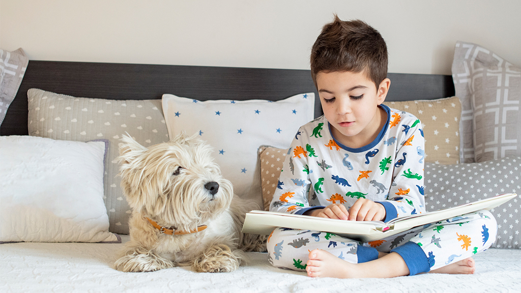 boys reads to his dog