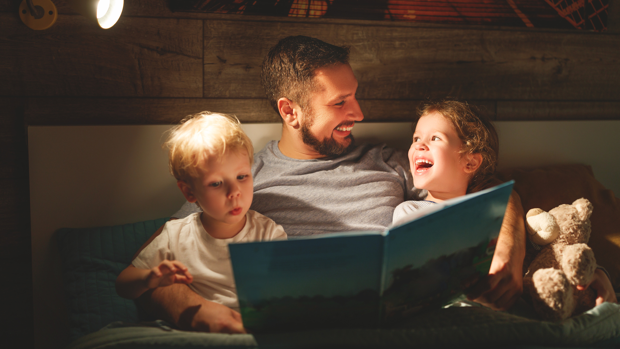 Male guardian reading a book to two children-Sanford fit