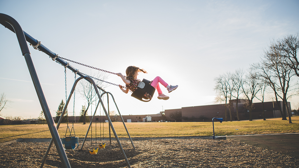 Child playing on swings - Sanford fit