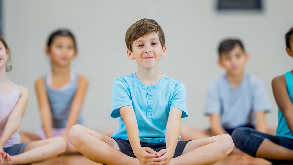 Children sitting and stretching together - Sanford fit