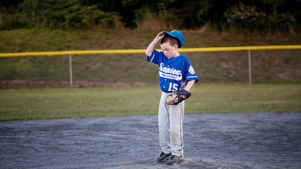 Baseball player standing alone on the field-Sanford Fit