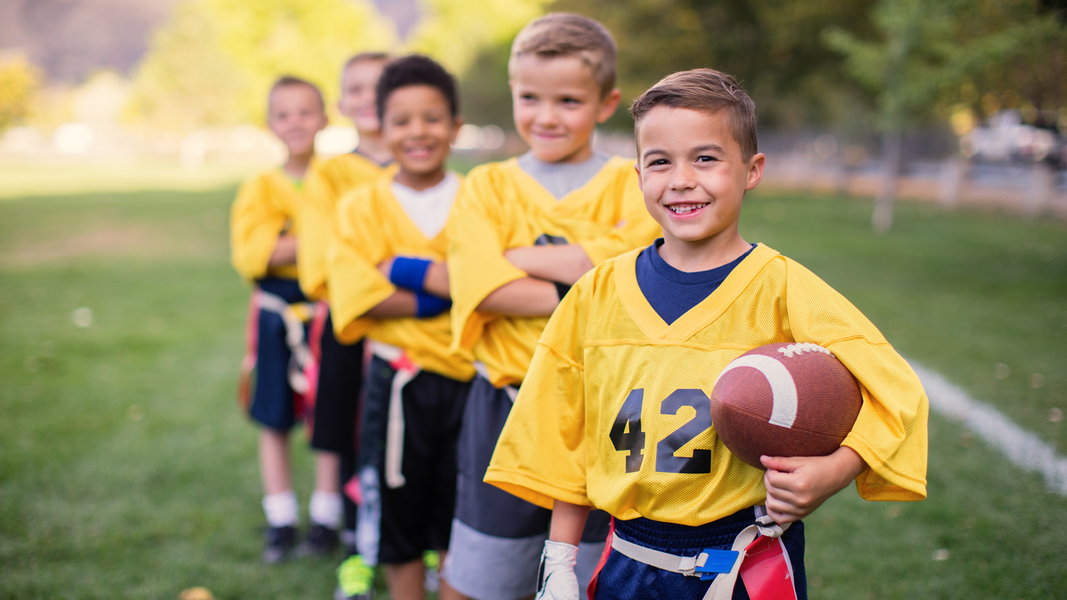 young football players standing on the field-Sanford Fit